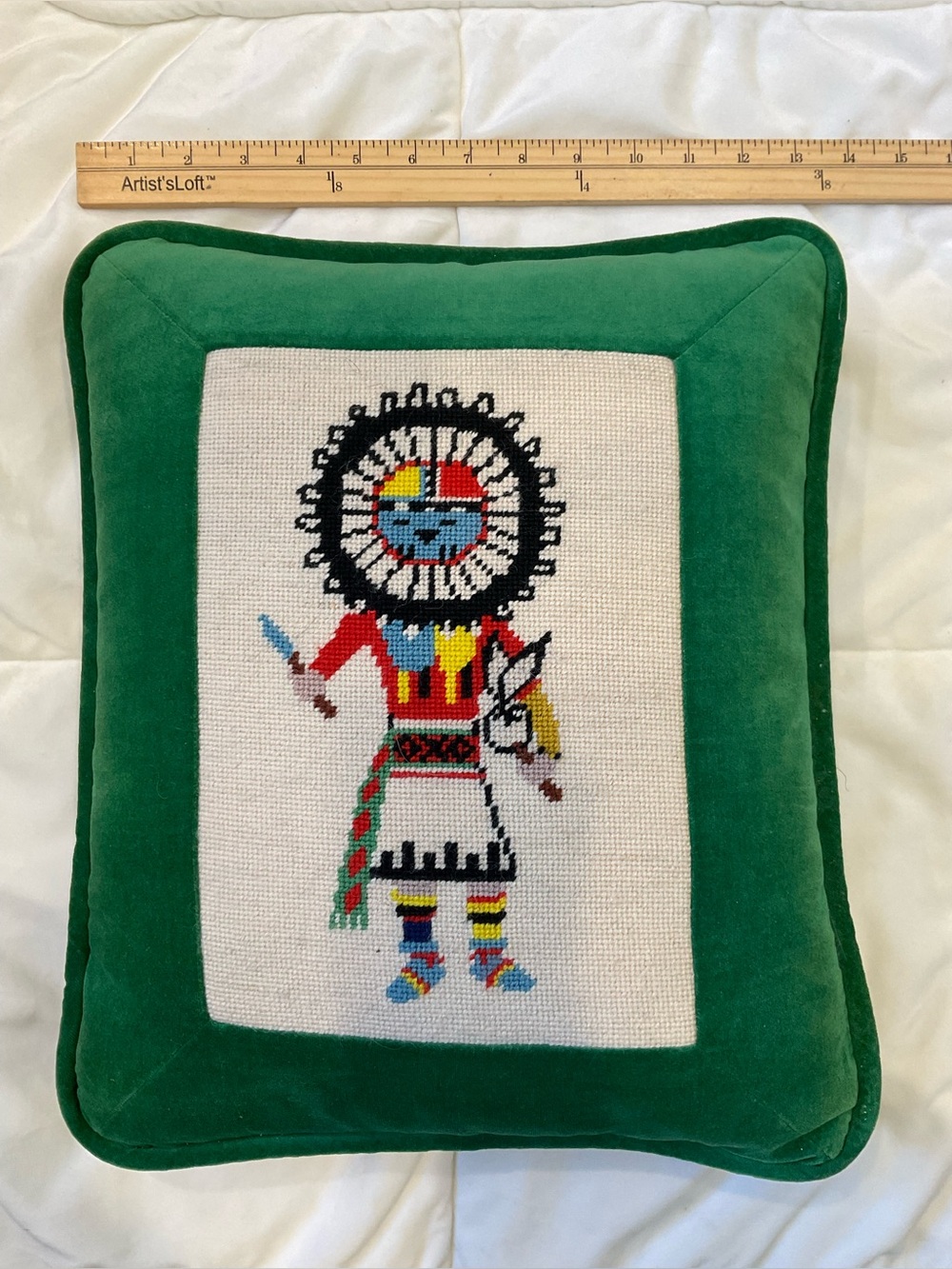 This is a vintage needlepoint decorative pillow featuring a colorful.